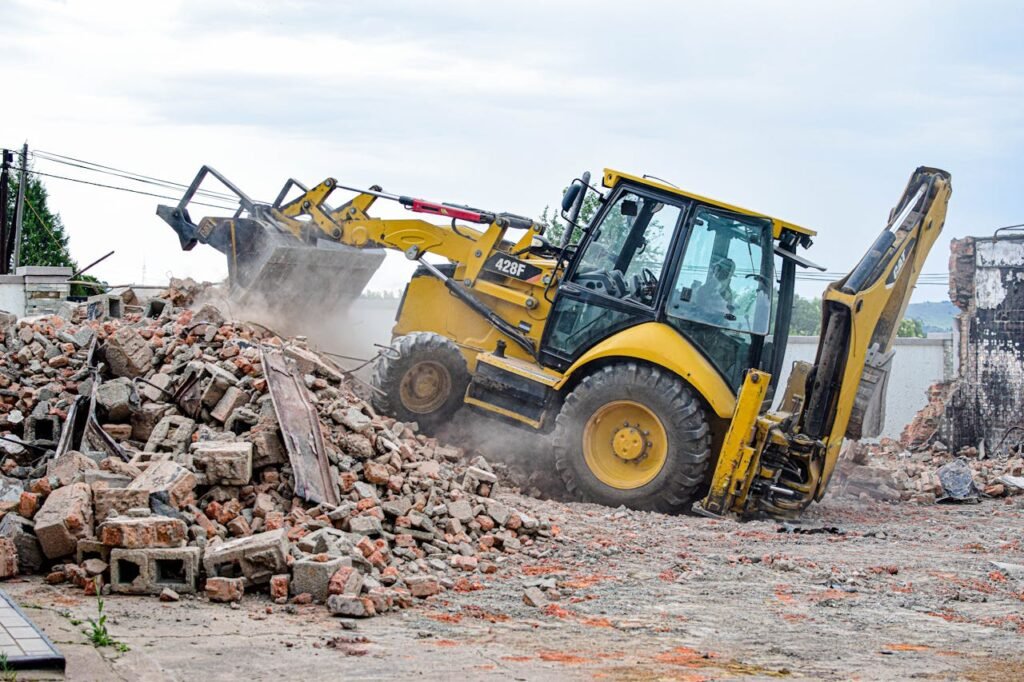 Excavator removing rubble at a demolition site in Maseru, Lesotho.